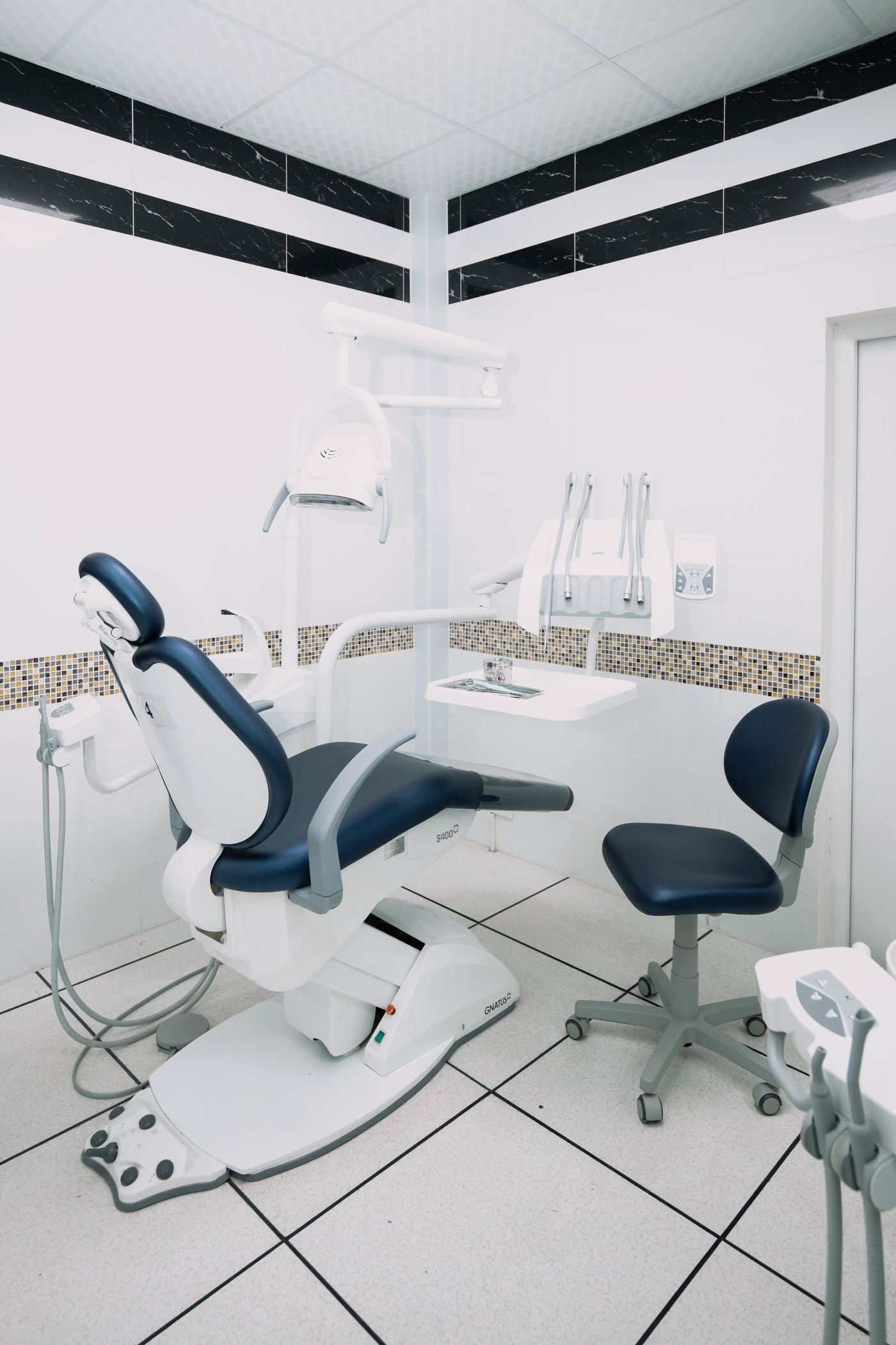 A modern dental treatment room with a dental chair and equipment